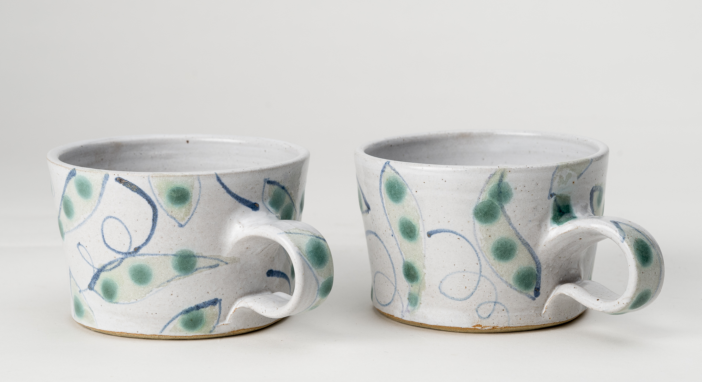 Low mugs in 'pea-pod' design.